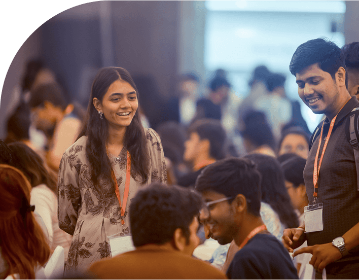 Delegates in lanyards talking to each other between sessions at an event